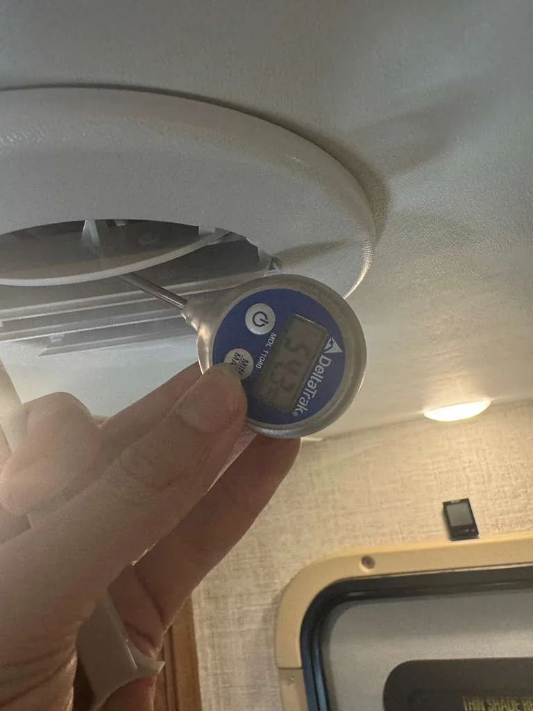 Checking temperature inside an RV during a mobile appliance service call in Florida