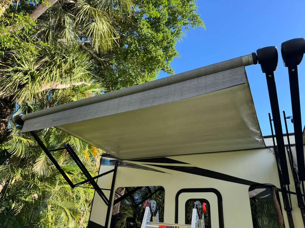Triton RV technician replacing an RV awning at a Florida campground
